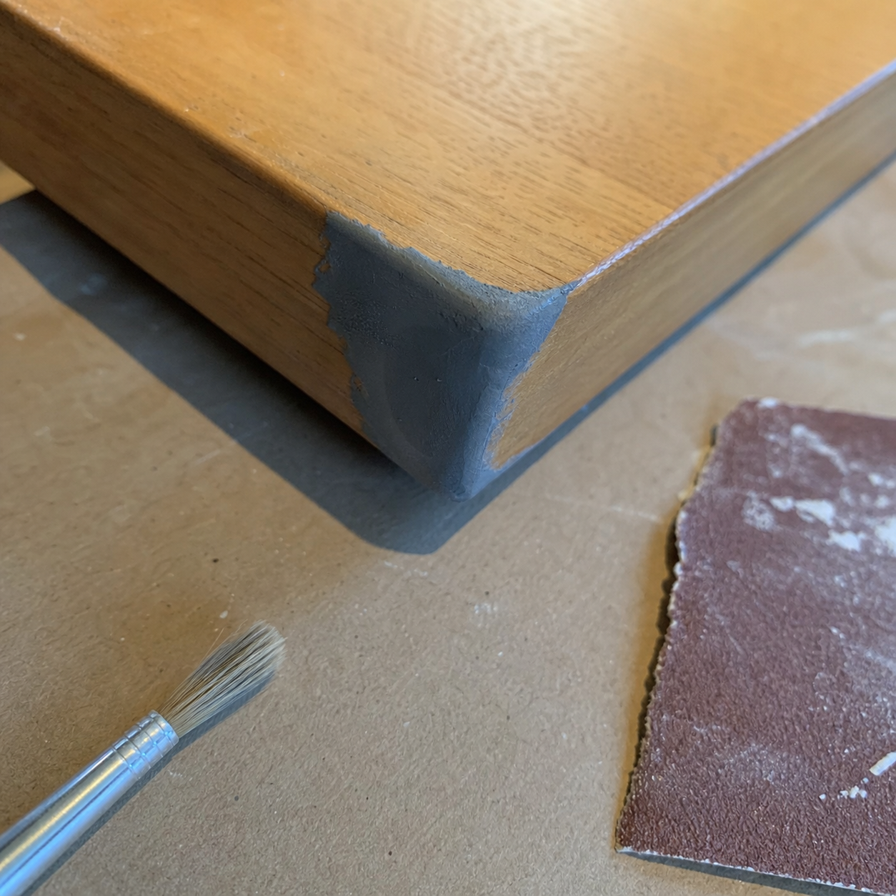Wood corner repaired with putty before sanding and painting